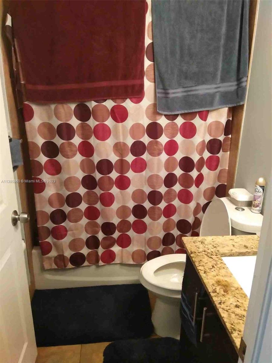 1968 Northwest 4th Court, Unit 323 Miami, FL 33136 - Photo 10 of 12 a bathroom with a granite countertop sink and a toilet