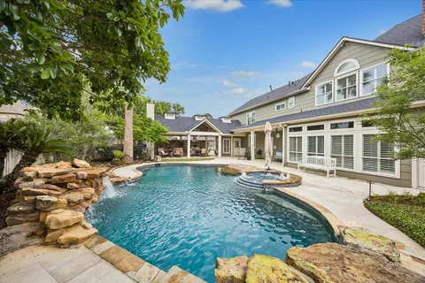 a front view of a house with swimming pool having outdoor seating