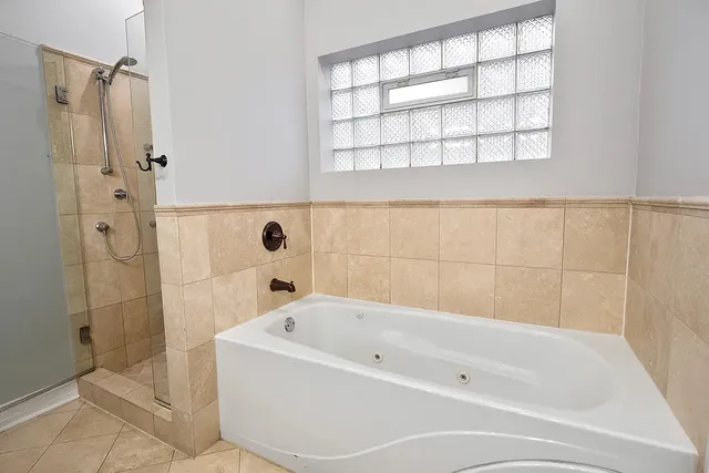 a bathroom with a bathtub and shower