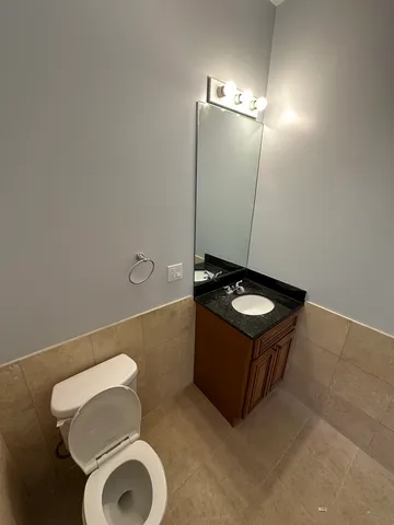 a bathroom with a toilet and a mirror