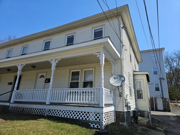 a view of a house with a wooden deck