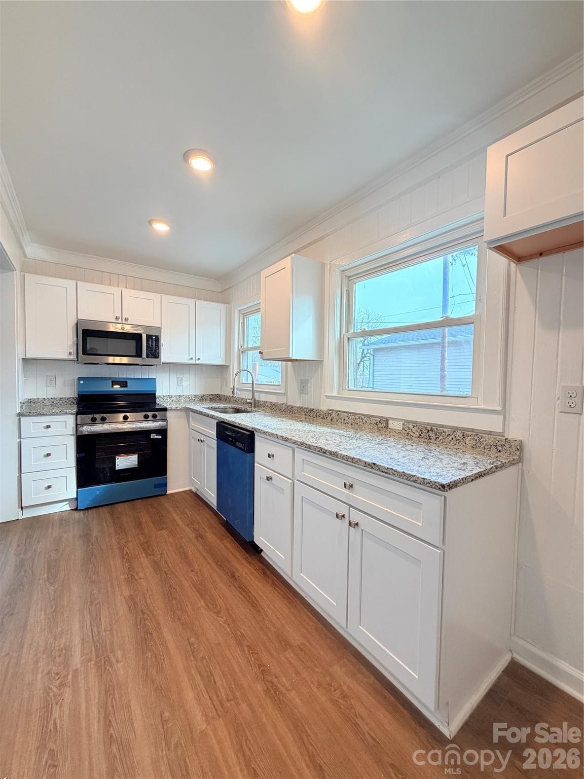 1114 Mt Olivet Road Kannapolis, NC 28083 - Photo 11 of 26 a kitchen with granite countertop a stove and cabinets