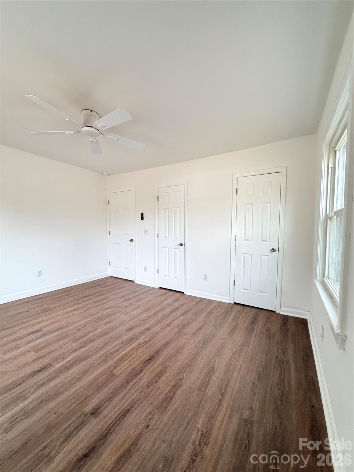 1114 Mt Olivet Road Kannapolis, NC 28083 - Photo 13 of 26 an empty room with wooden floor and windows