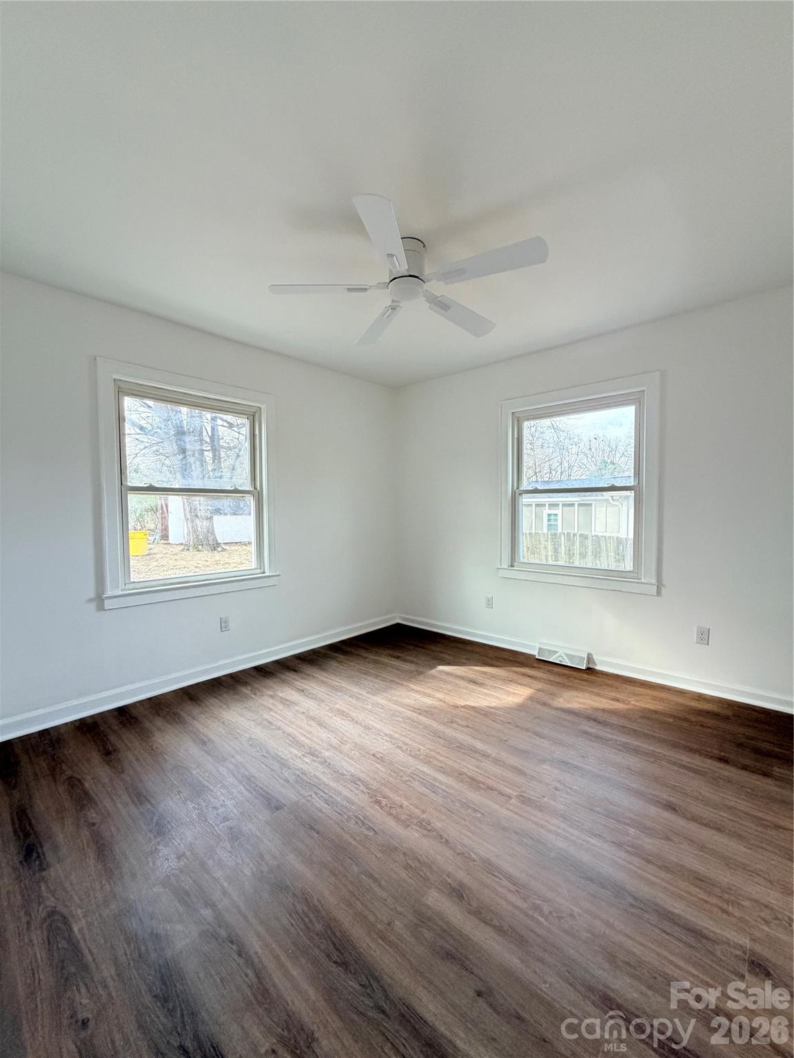 1114 Mt Olivet Road Kannapolis, NC 28083 - Photo 14 of 26 an empty room with wooden floor ceiling fan and windows