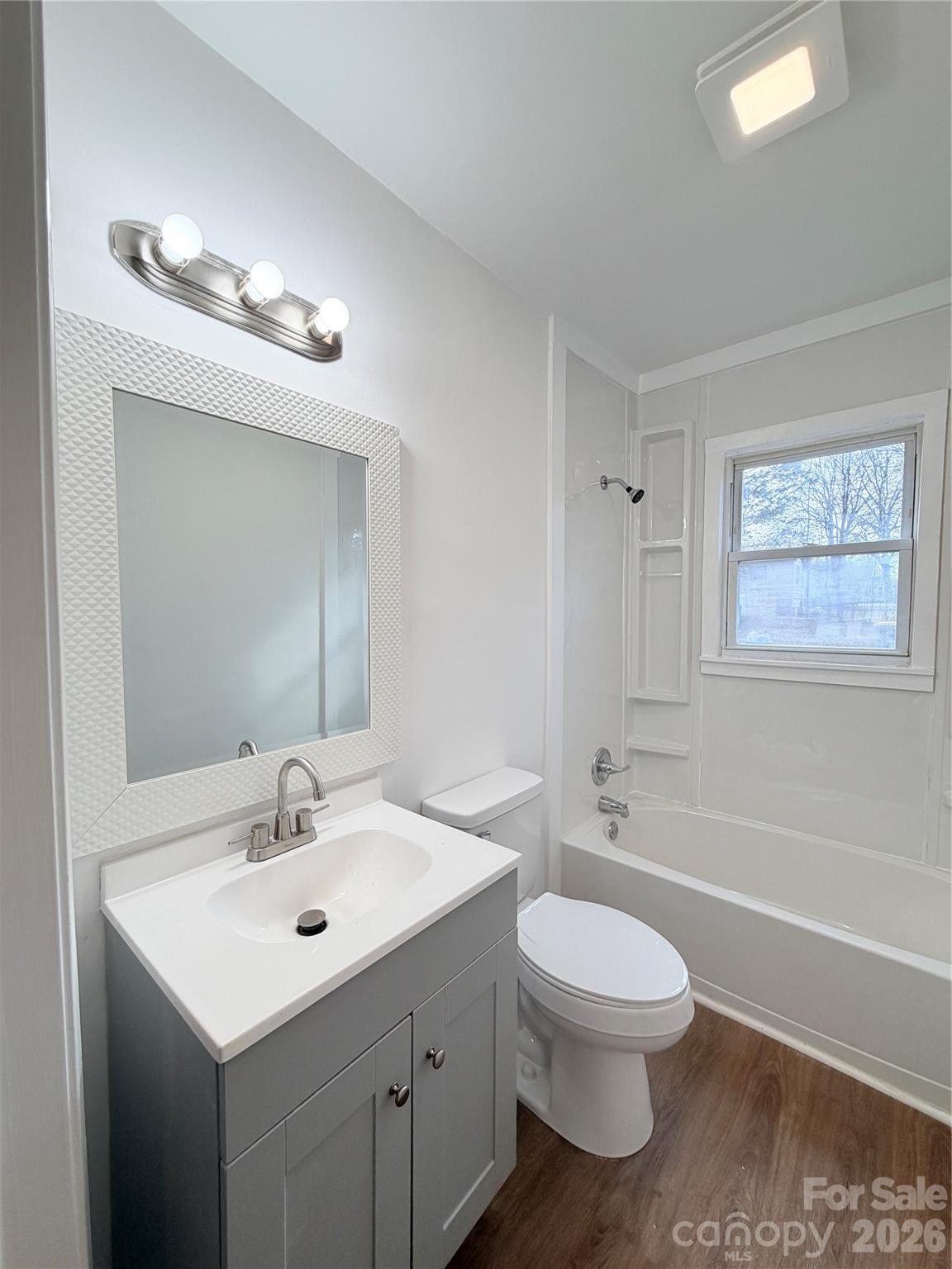1114 Mt Olivet Road Kannapolis, NC 28083 - Photo 18 of 26 a bathroom with a toilet a sink a mirror and a bathtub