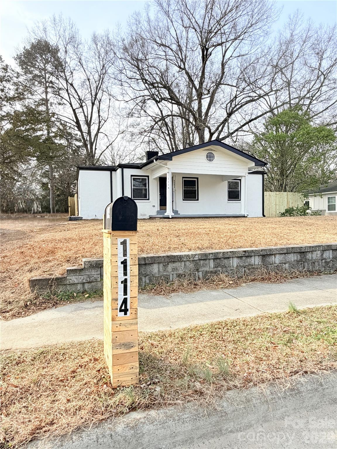 1114 Mt Olivet Road Kannapolis, NC 28083 - Photo 2 of 26 a front view of a house with garden and trees