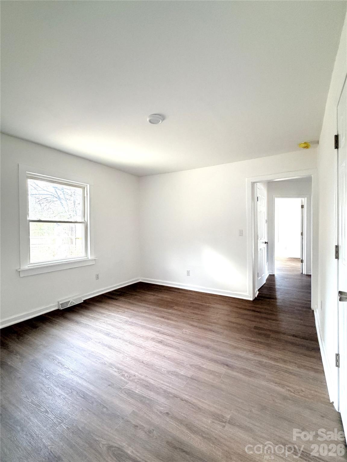 1114 Mt Olivet Road Kannapolis, NC 28083 - Photo 21 of 26 an empty room with wooden floor and windows