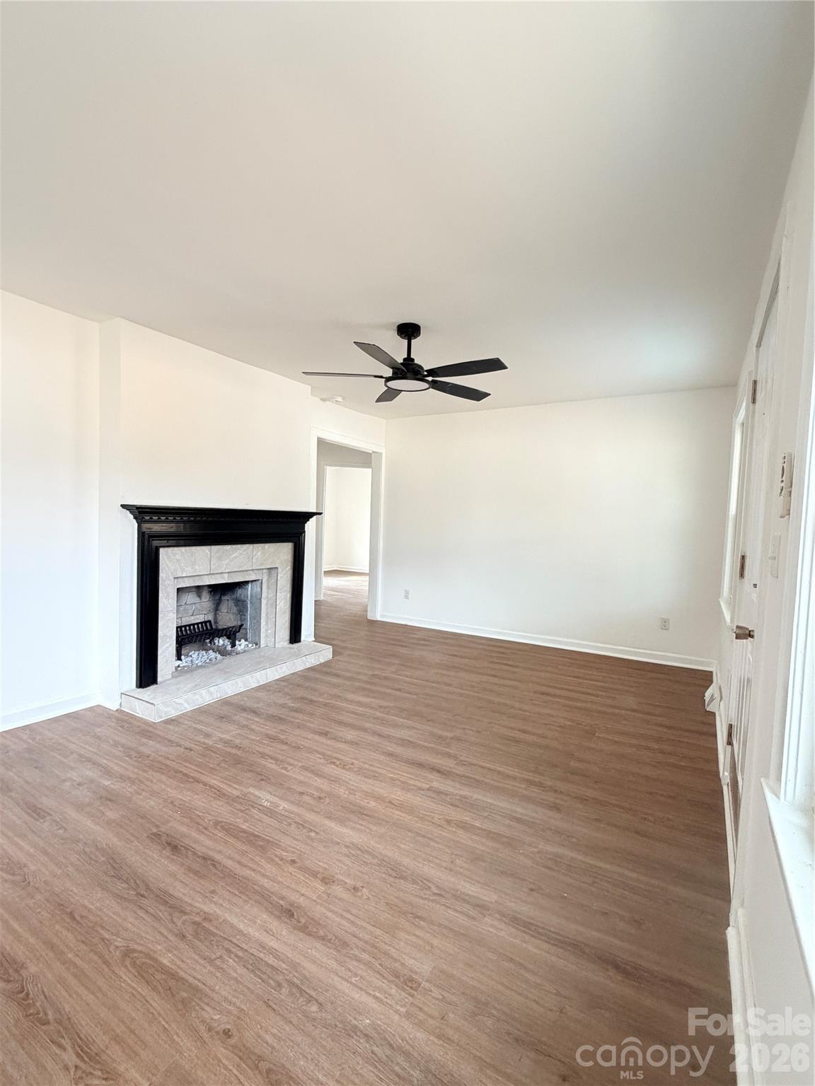 1114 Mt Olivet Road Kannapolis, NC 28083 - Photo 7 of 26 a view of empty room with wooden floor and fireplace