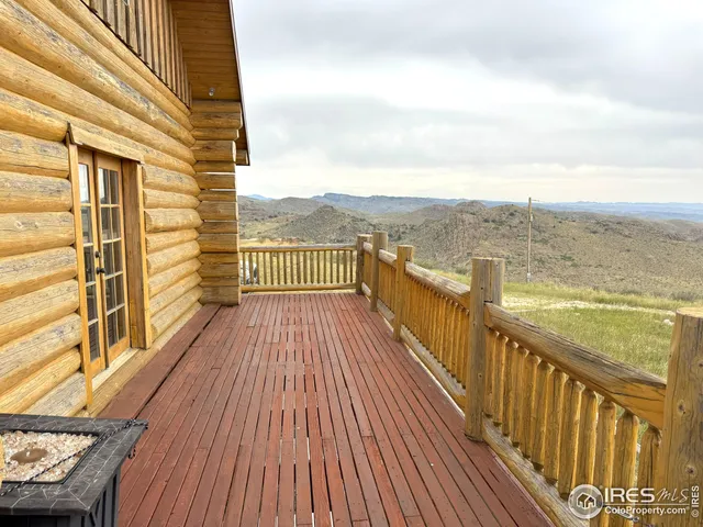 a view of balcony with wooden floor and fence