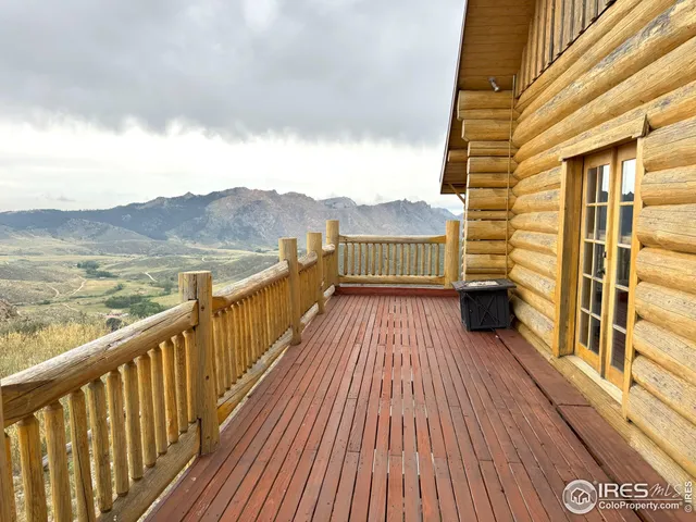 a view of balcony with wooden floor and fence
