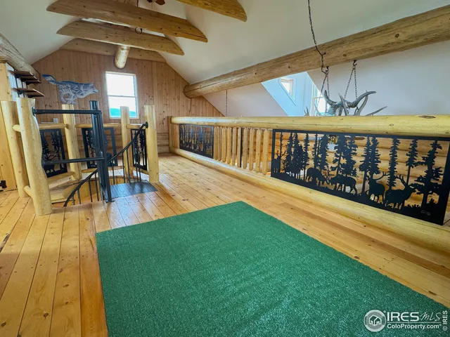 a view of swimming pool with a dining table chairs and wooden floor