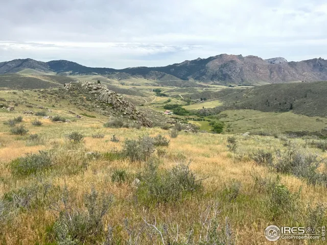 a view of mountain with an ocean