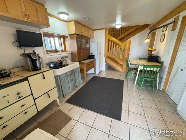 a living room with furniture a flat screen tv and a stove
