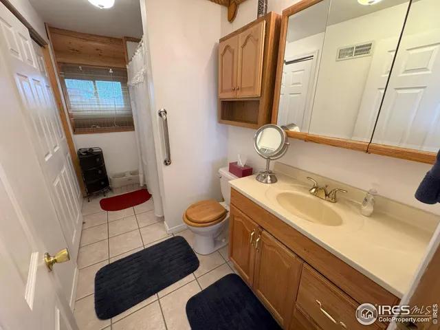 a bathroom with a sink toilet and mirror