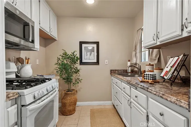 a kitchen with stainless steel appliances granite countertop a stove and cabinets