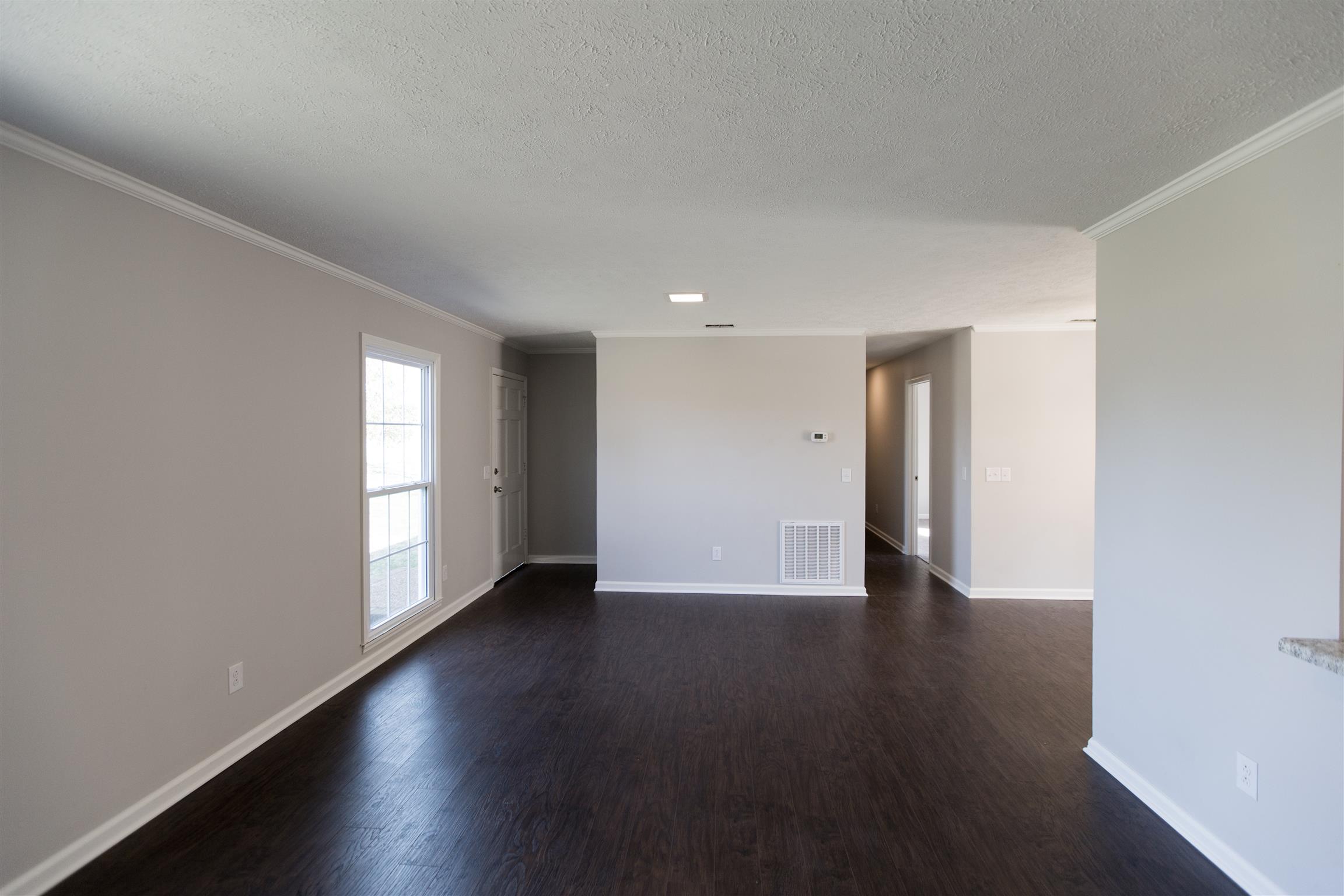 6339 Gum Station Road Springfield, TN 37172 - Photo 4 of 21 a view of an empty room with wooden floor and windows