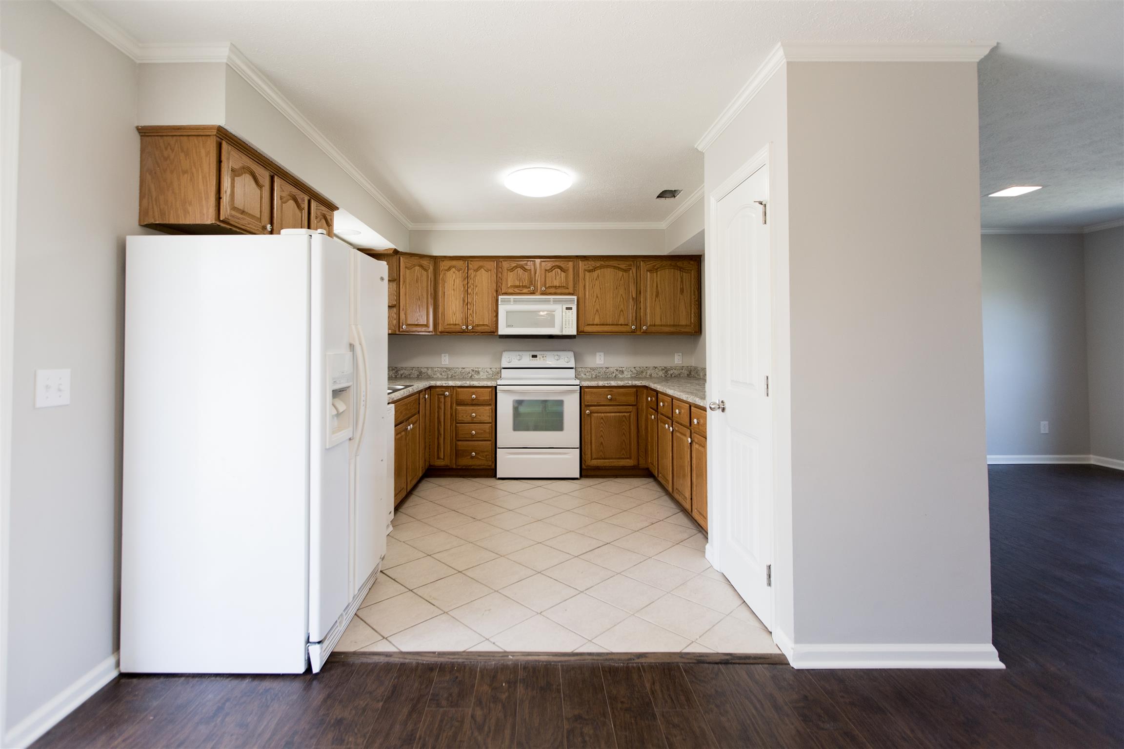 6339 Gum Station Road Springfield, TN 37172 - Photo 8 of 21 a kitchen with a refrigerator a stove top oven a sink and dishwasher