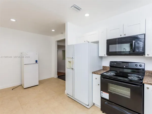 a kitchen with a refrigerator stove and microwave