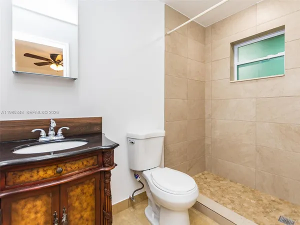 a bathroom with a sink a toilet and a shower curtain