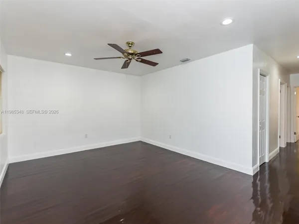 an empty room with a empty space and a ceiling fan