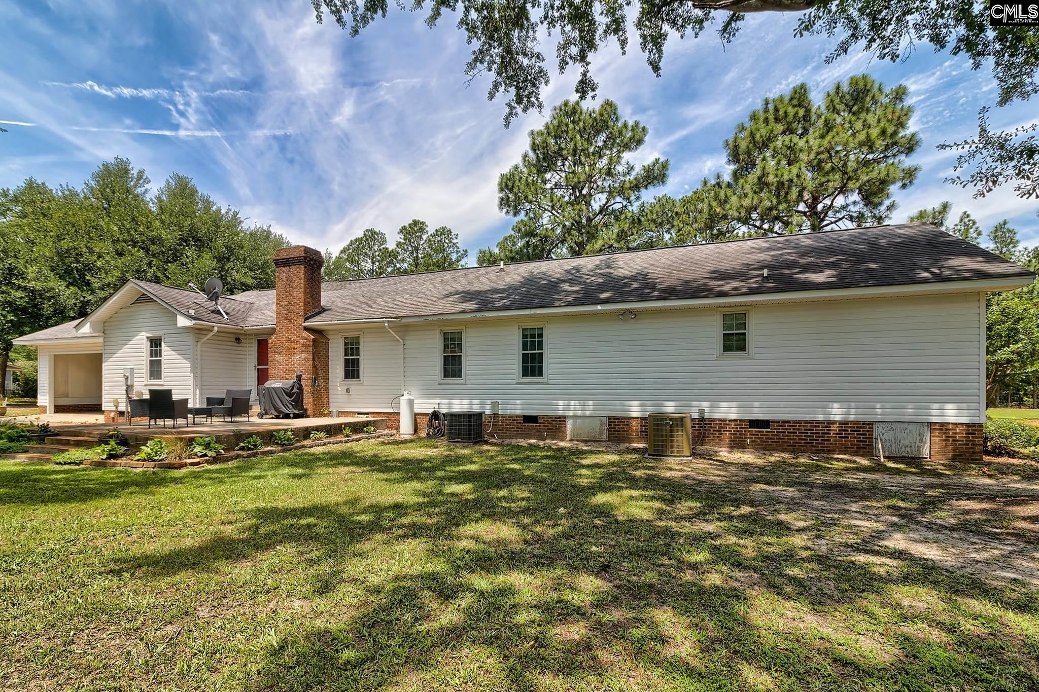 1415 State Rd S-28-55 Lugoff, SC 29078 - Photo 5 of 39 a front view of a house with a yard