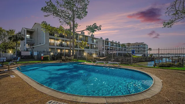 a view of a swimming pool with a yard
