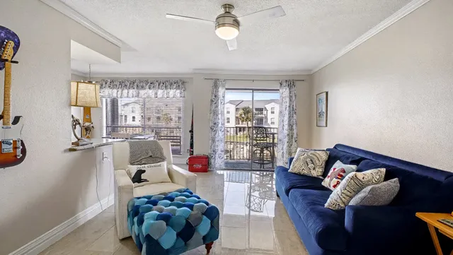 a bedroom with furniture and a large window