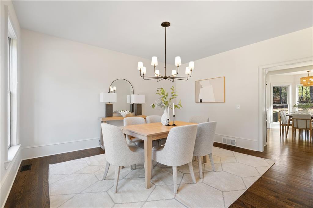11125 Linbrook Lane Johns Creek, GA 30097 - Photo 14 of 44 a view of a dining room with furniture wooden floor and chandelier