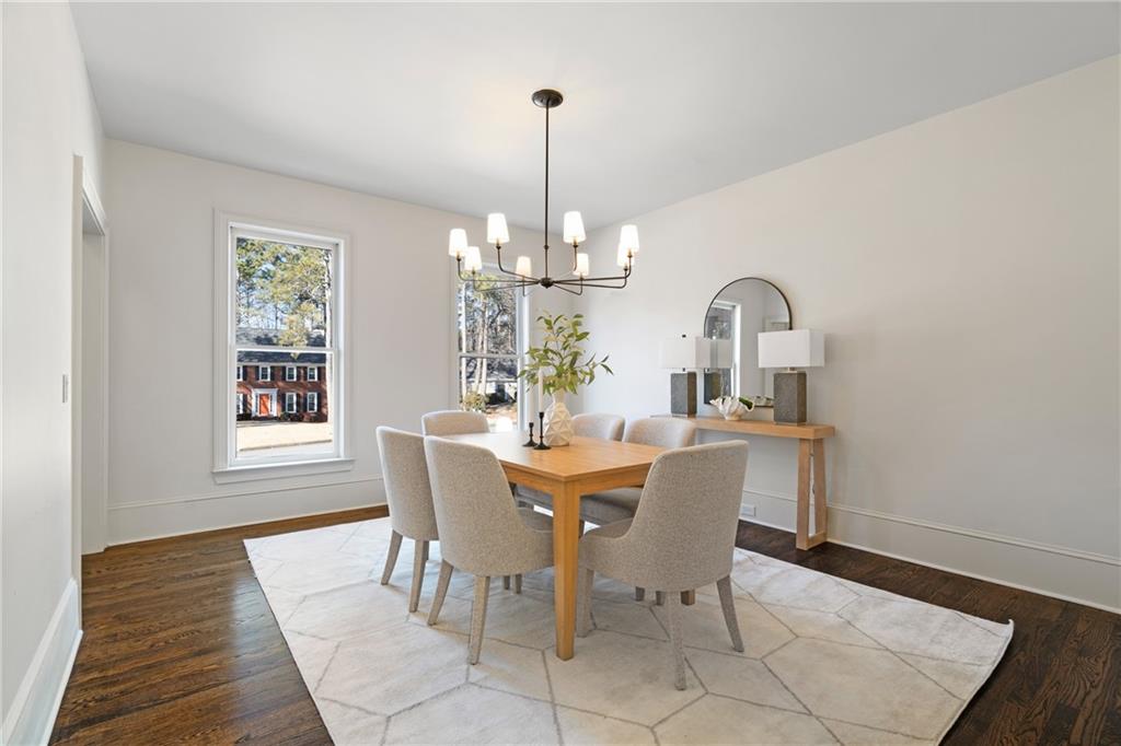 11125 Linbrook Lane Johns Creek, GA 30097 - Photo 15 of 44 a dining room with wooden floor a chandelier a wooden table and chairs