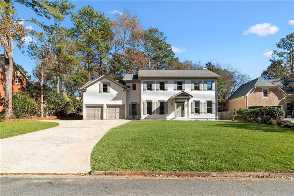 11125 Linbrook Lane Johns Creek, GA 30097 - Photo 2 of 44 a front view of a house with a yard