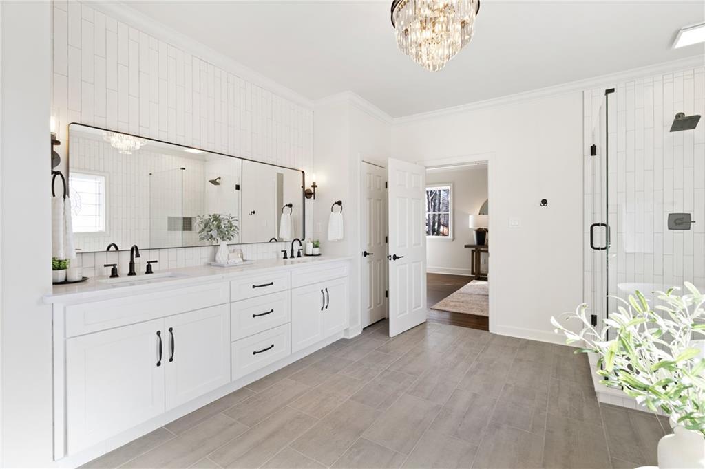 11125 Linbrook Lane Johns Creek, GA 30097 - Photo 33 of 44 a spacious bathroom with a double vanity sink a large mirror a shower and a bathtub