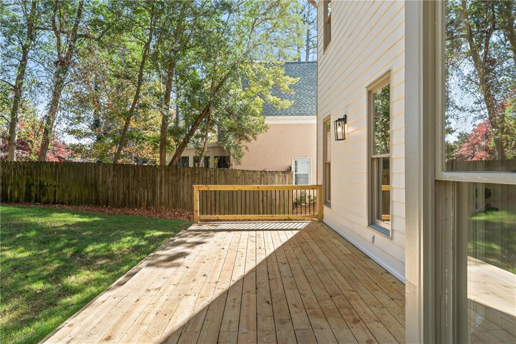 11125 Linbrook Lane Johns Creek, GA 30097 - Photo 41 of 44 a view of a backyard with wooden fence and large trees