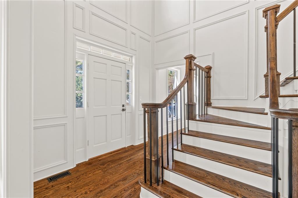 11125 Linbrook Lane Johns Creek, GA 30097 - Photo 9 of 44 a view of front door with wooden floor and stairs