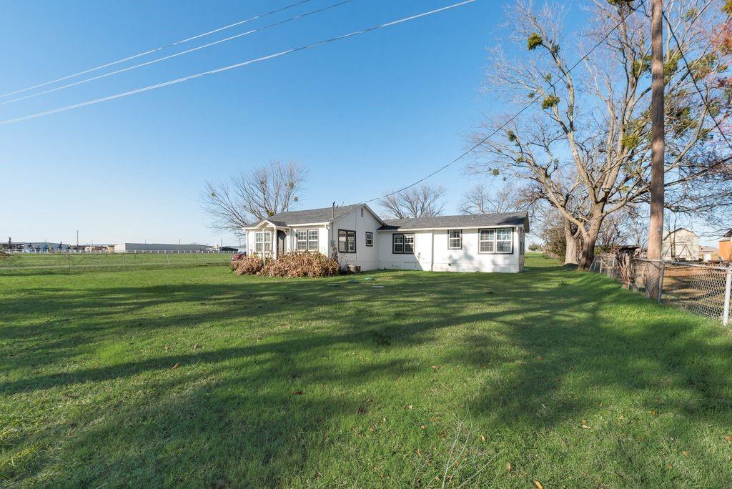 a view of a big house with a big yard
