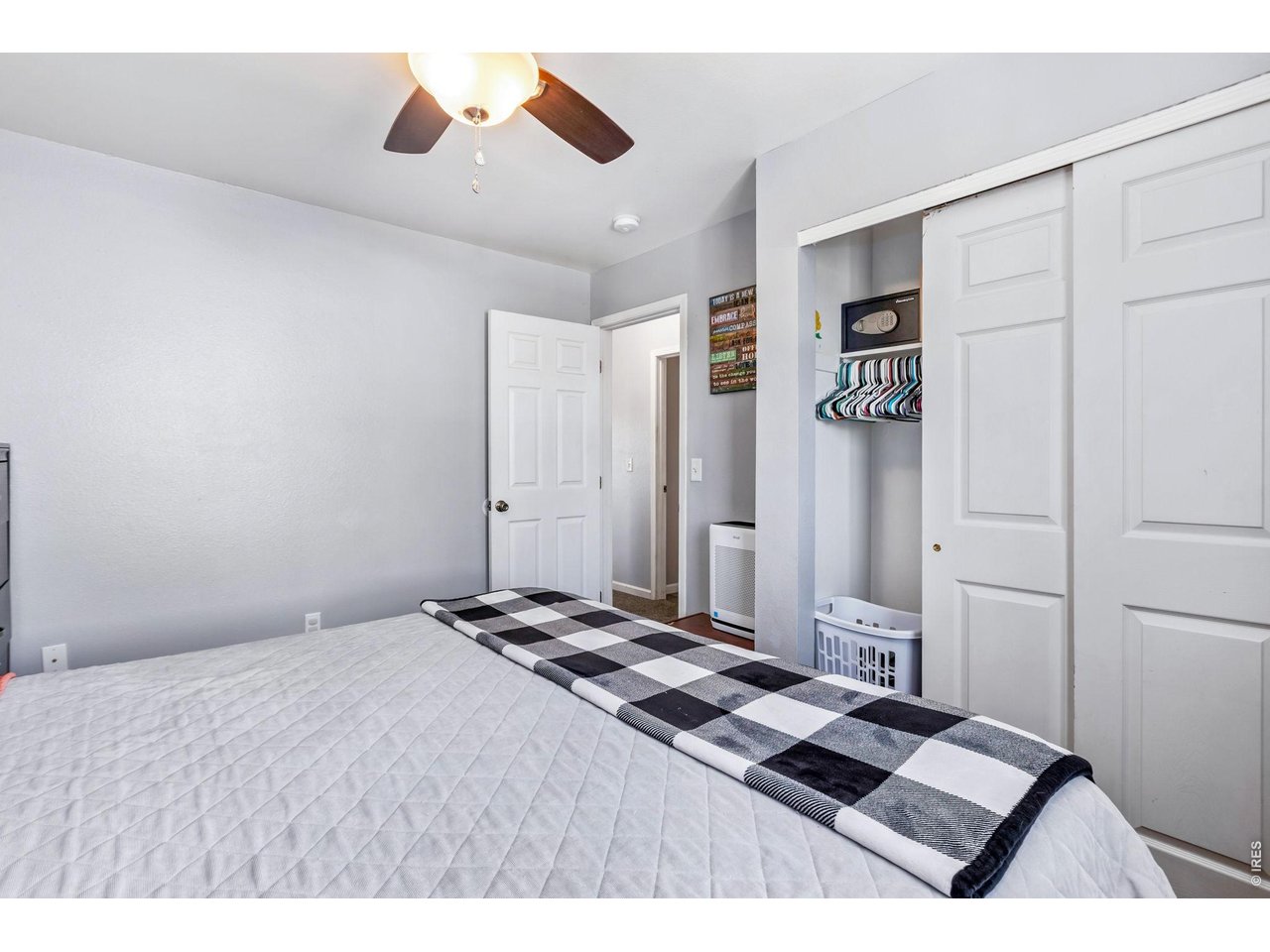 233 East 19th Street Road Greeley, CO 80631 - Photo 15 of 22 a bedroom with a bed and lamp