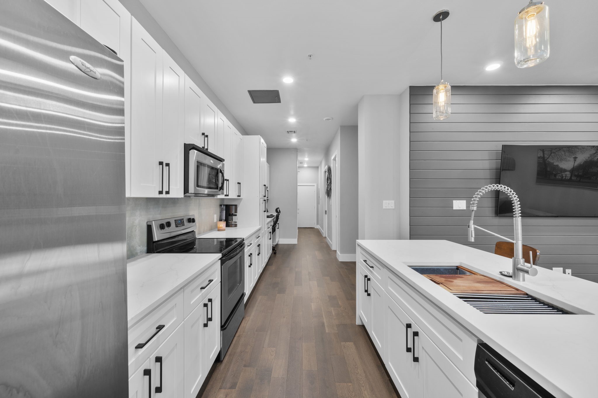 207 Pierce Street, Unit 209 Houston, TX 77002 - Photo 6 of 13 a kitchen with stainless steel appliances a sink stove and cabinets