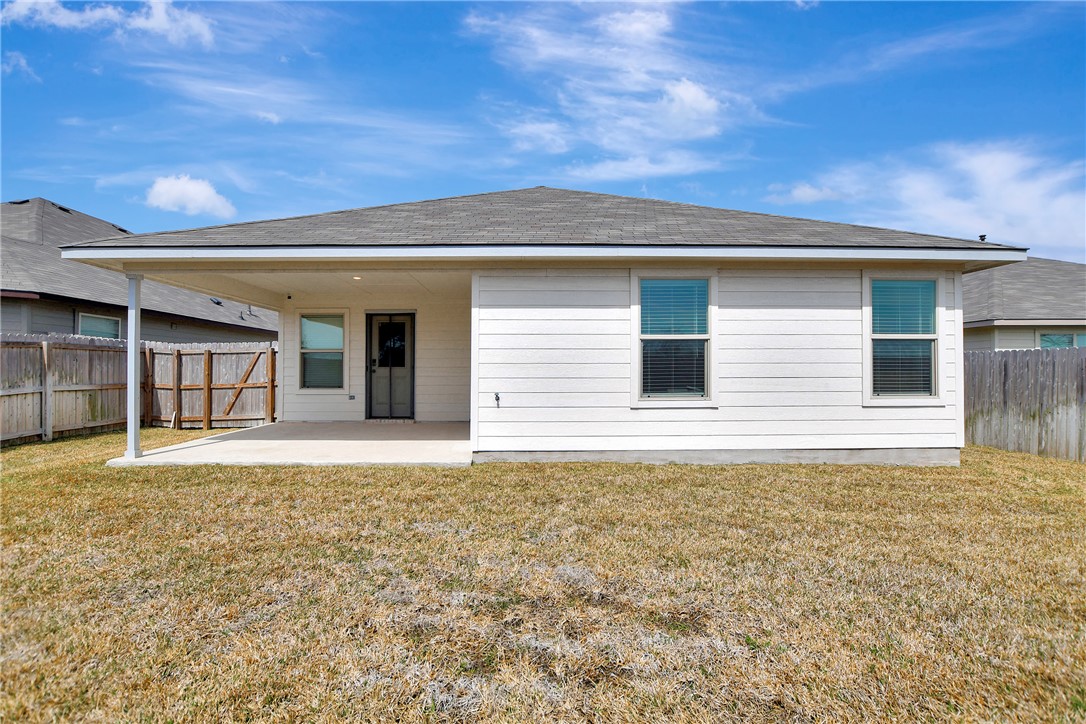 909 Davy Street Brenham, TX 77833 - Photo 29 of 35 Rear view of property with a patio area and a fenced backyard