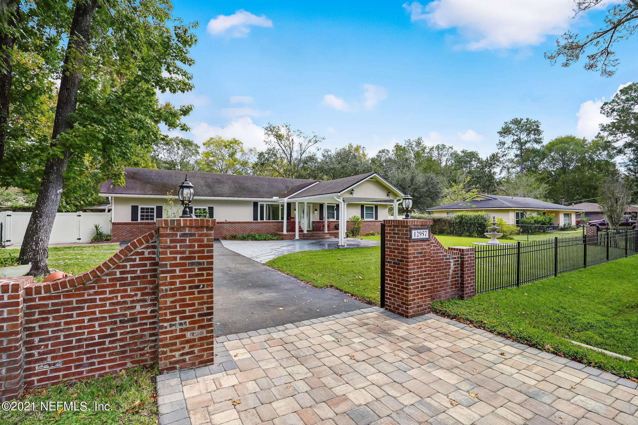 12957 Mandarin Road Jacksonville, FL 32223 - Photo 4 of 83 a front view of a house with a garden
