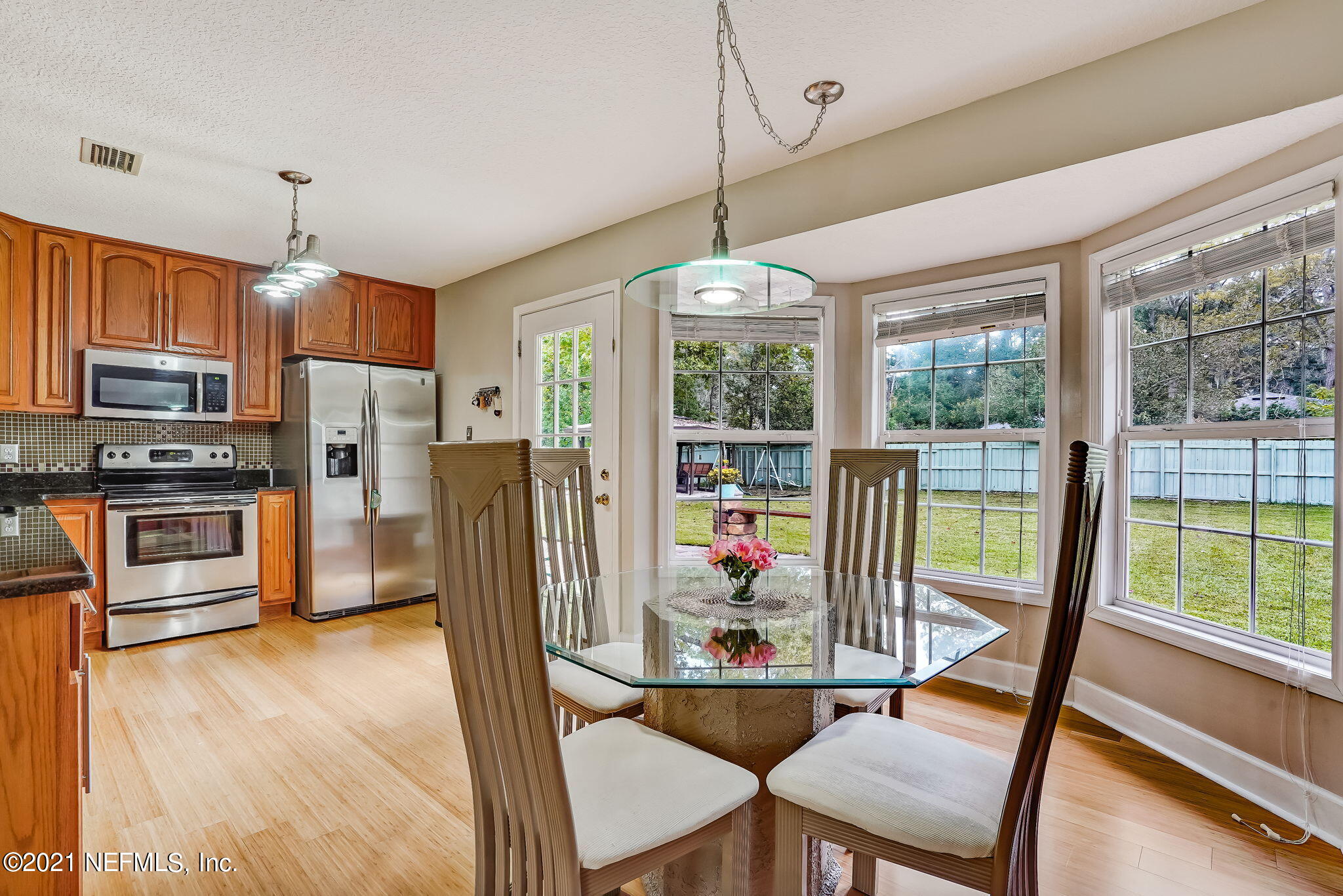 12957 Mandarin Road Jacksonville, FL 32223 - Photo 46 of 83 a view of a dining room with furniture large window and wooden floor