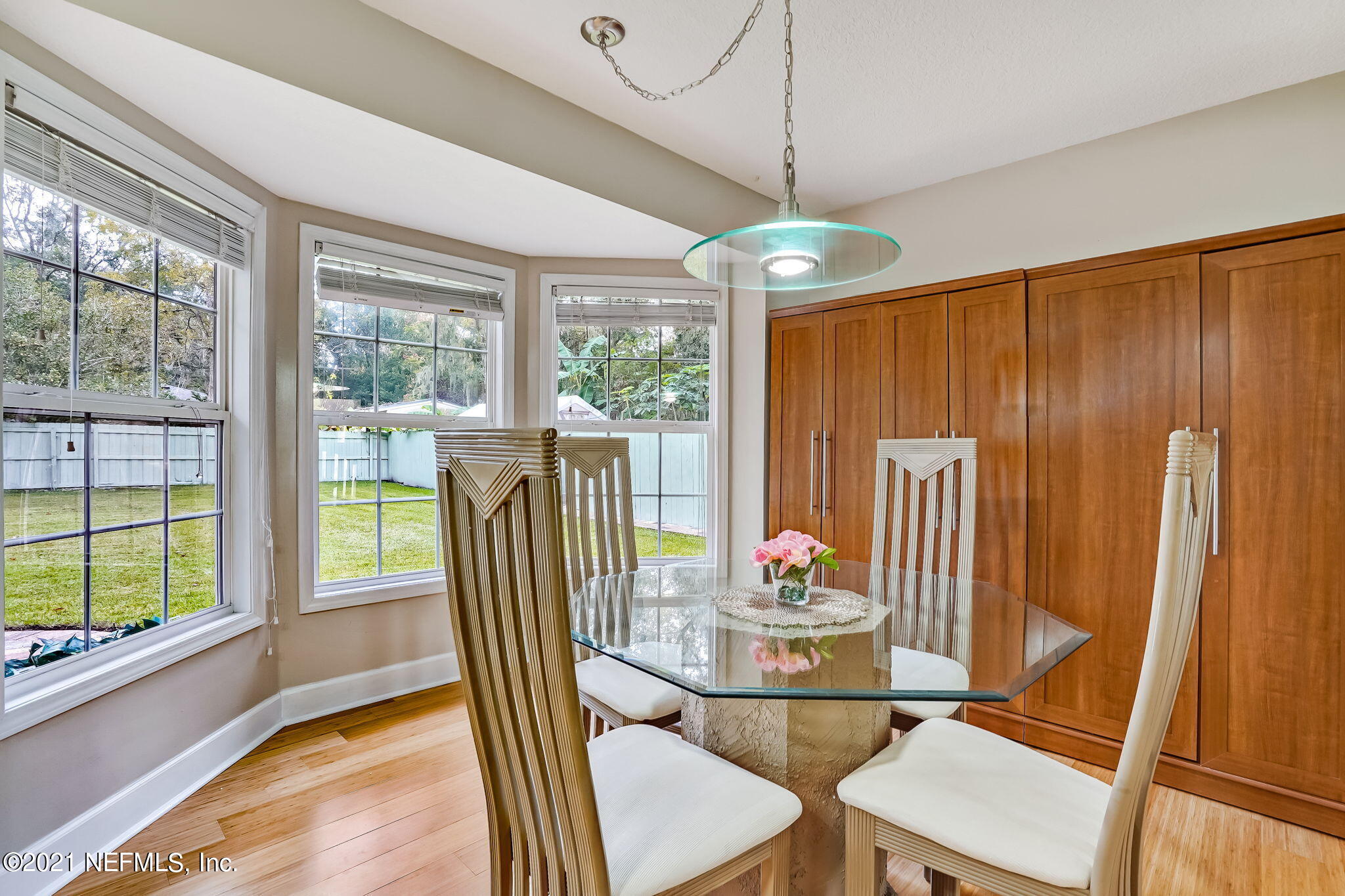12957 Mandarin Road Jacksonville, FL 32223 - Photo 47 of 83 a dining room with furniture a chandelier and wooden floor