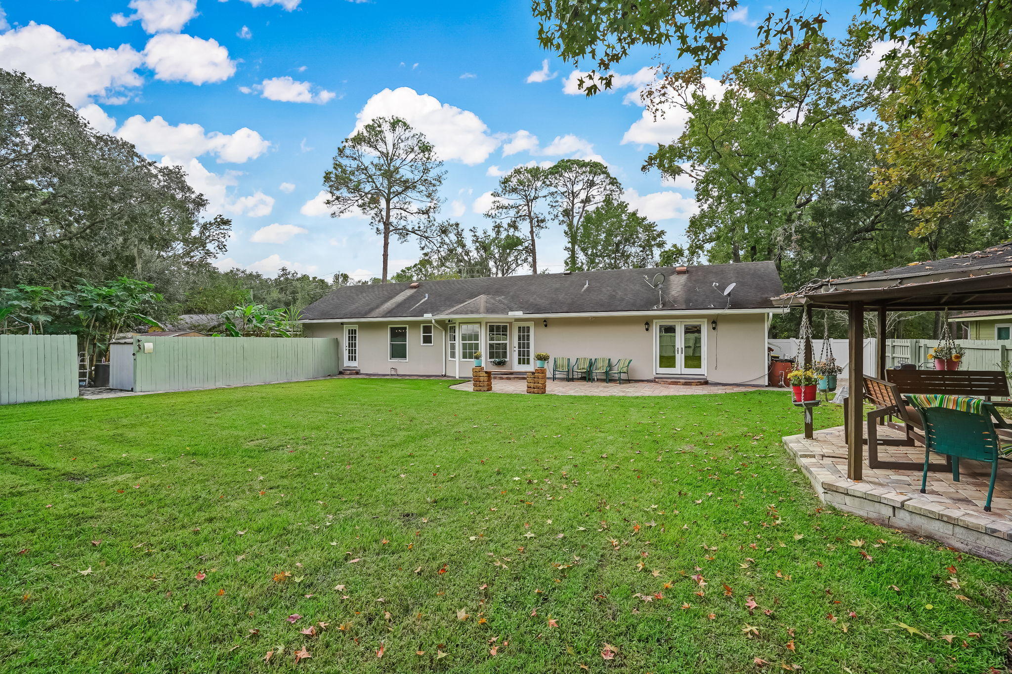 12957 Mandarin Road Jacksonville, FL 32223 - Photo 70 of 83 a view of a house with a backyard porch and sitting area