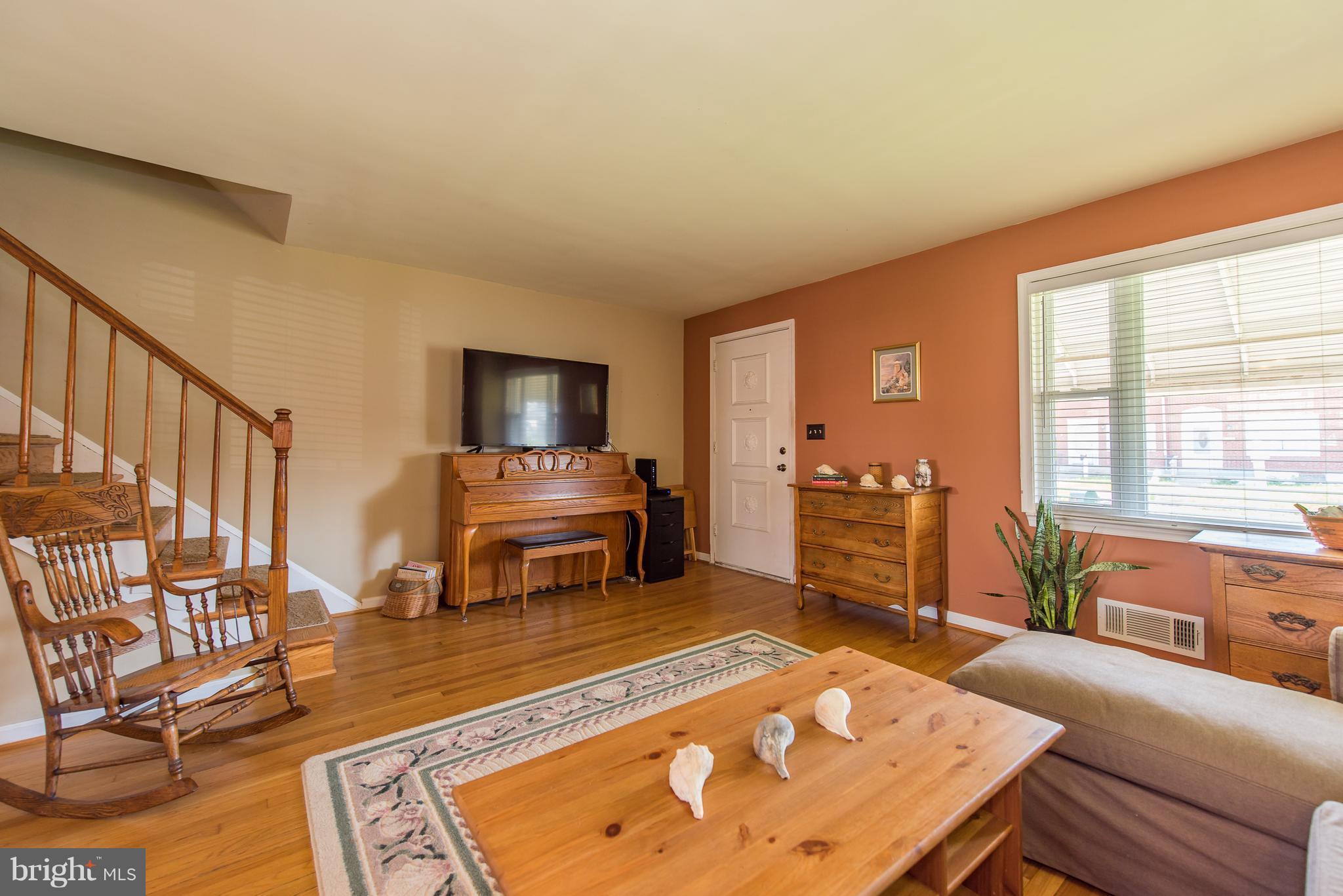 2223 Redthorn Road Baltimore, MD 21220 - Photo 3 of 30 a living room with furniture and a dining table with rug floor