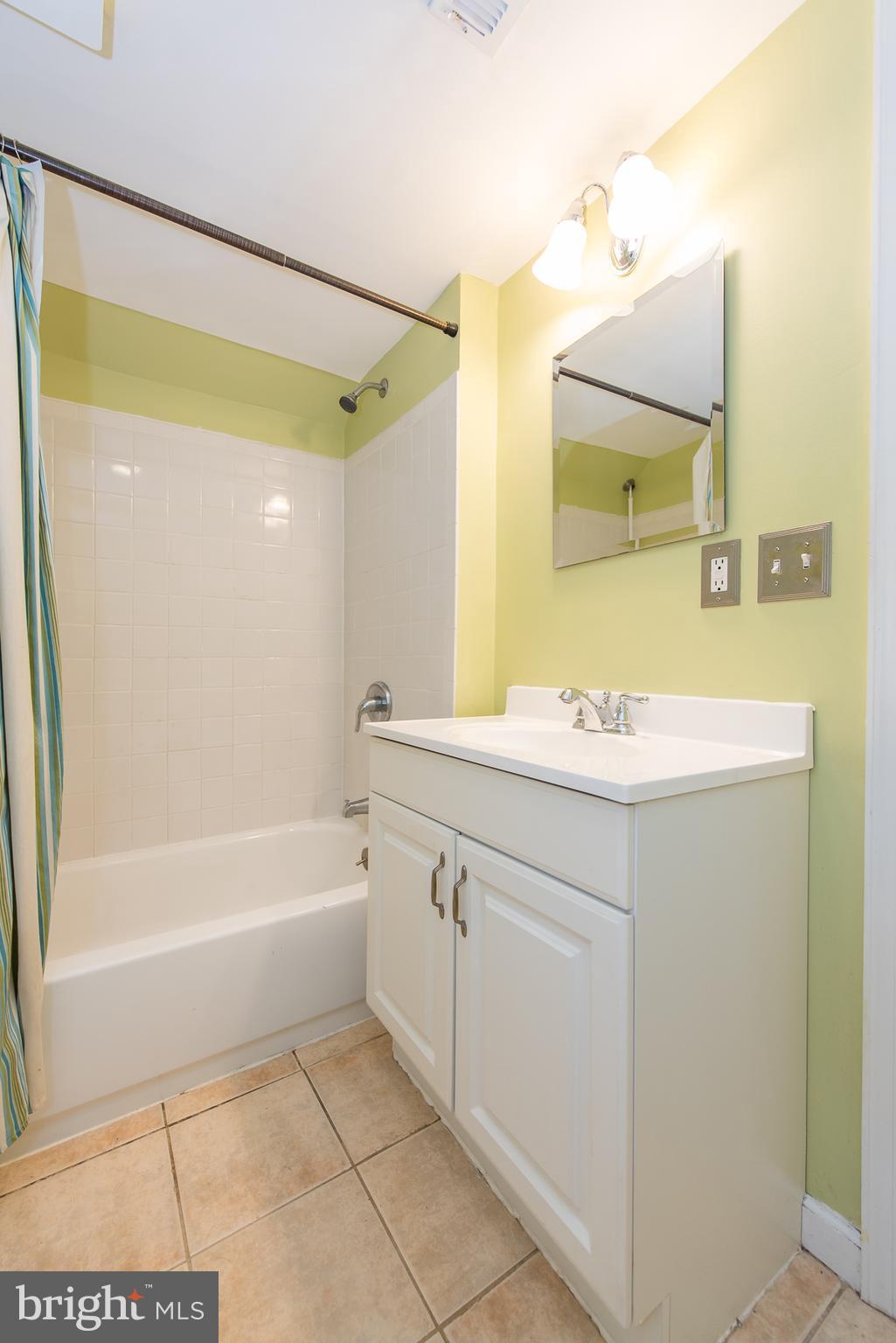 2223 Redthorn Road Baltimore, MD 21220 - Photo 23 of 30 a bathroom with a sink mirror and a bathtub