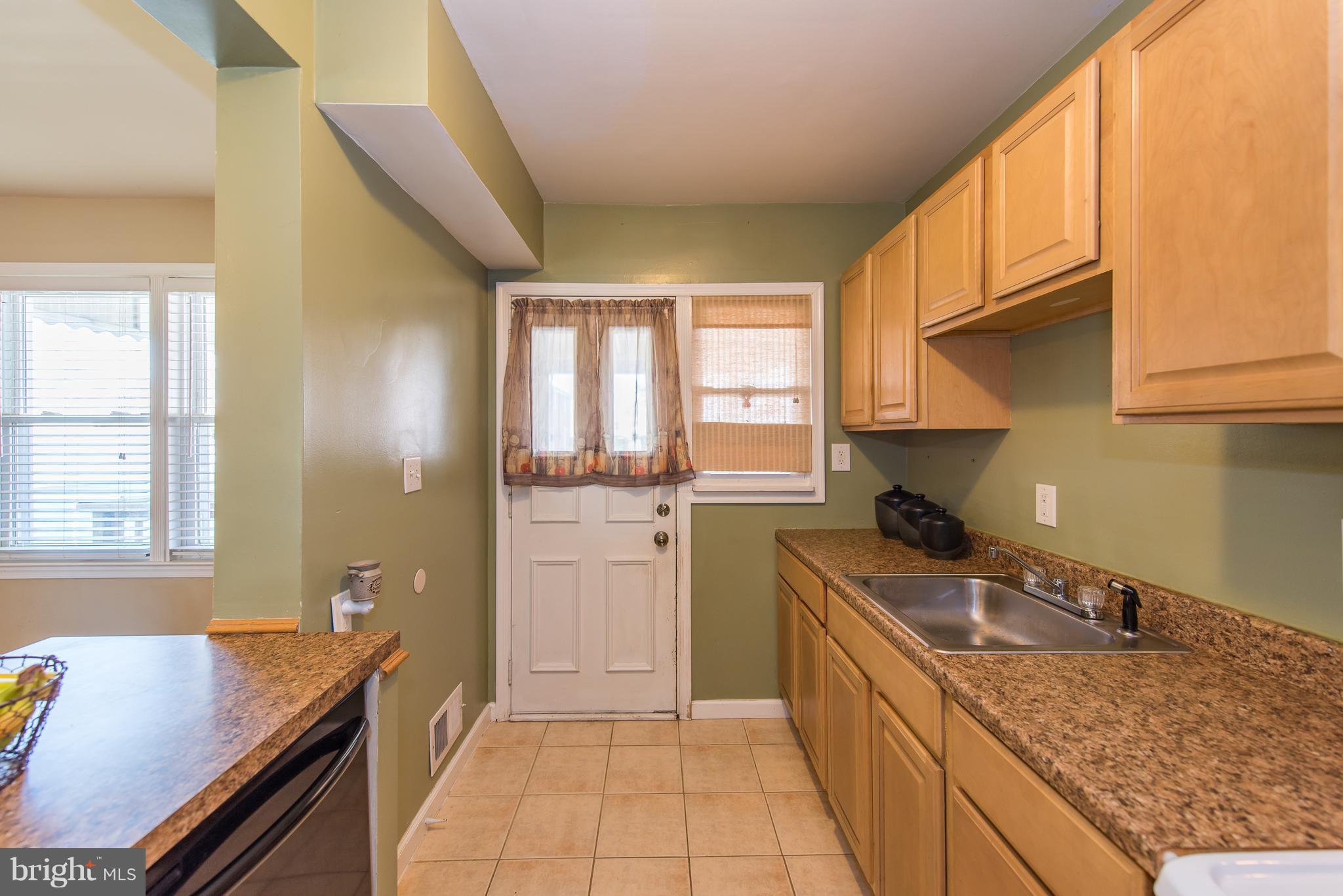2223 Redthorn Road Baltimore, MD 21220 - Photo 7 of 30 a kitchen with a sink stove and cabinets