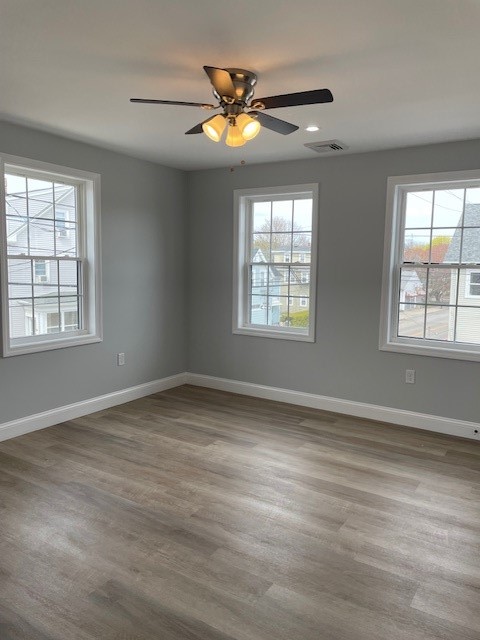 228 State Street, Unit 2 Bristol, RI 02809 - Photo 13 of 19 SECOND FLOOR BEDROOM WITH LAMINATED FLOOR AND CEILING FAN