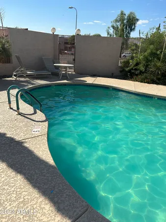 a view of a swimming pool with a yard