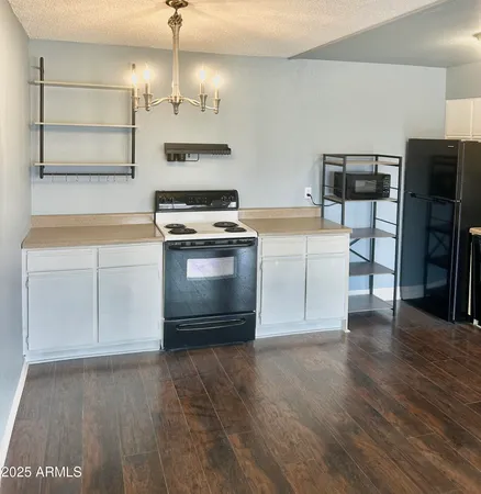 a kitchen with stainless steel appliances granite countertop a stove and a refrigerator