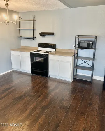 a kitchen with wooden floors and a stove