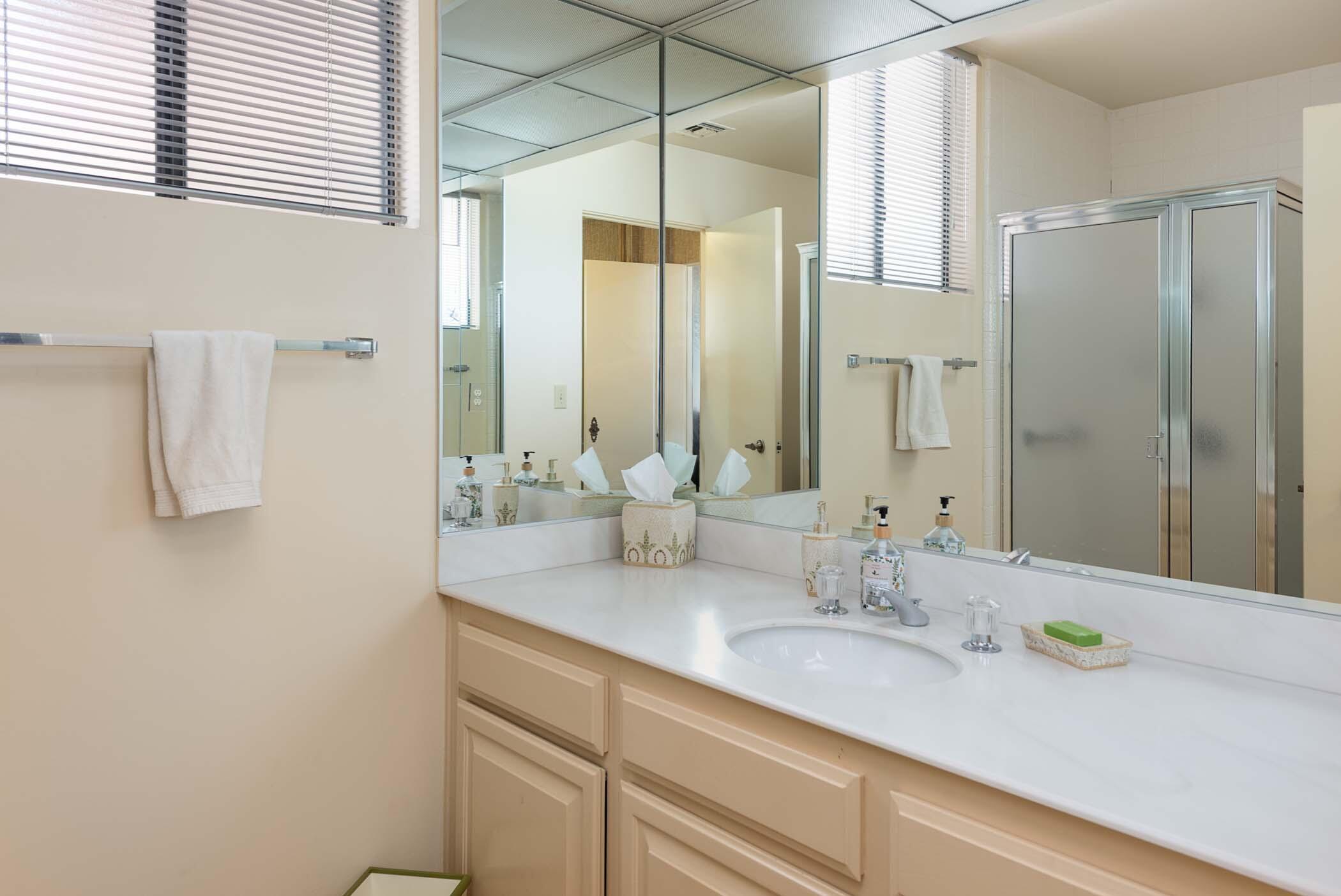 8 Tulane Court Rancho Mirage, CA 92270 - Photo 18 of 31 a bathroom with a granite countertop sink and a mirror