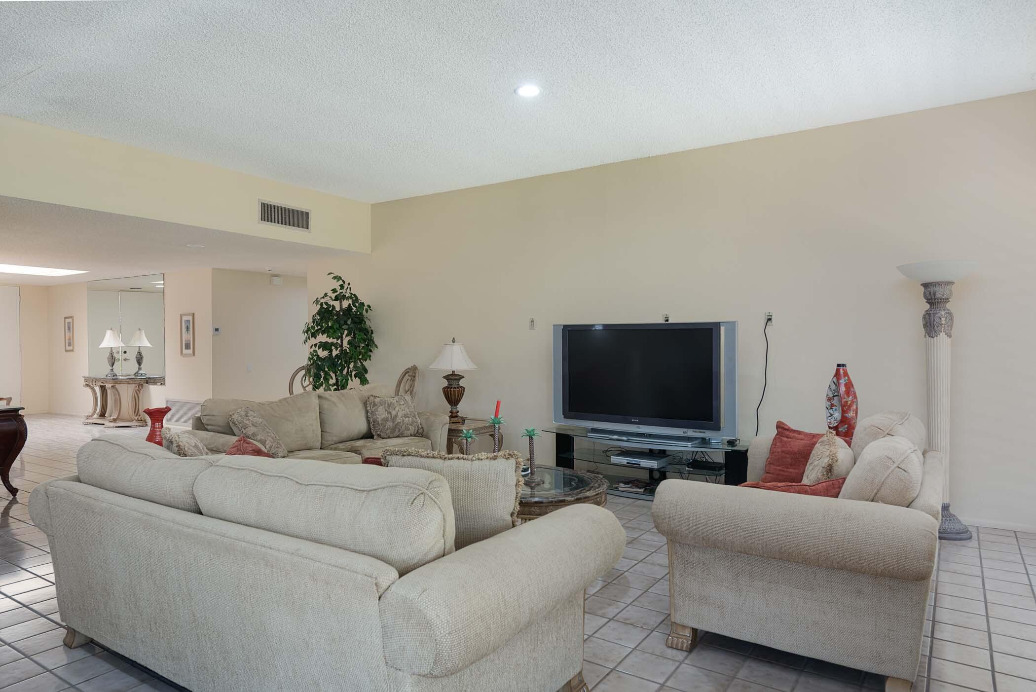 8 Tulane Court Rancho Mirage, CA 92270 - Photo 23 of 31 a living room with furniture and a flat screen tv